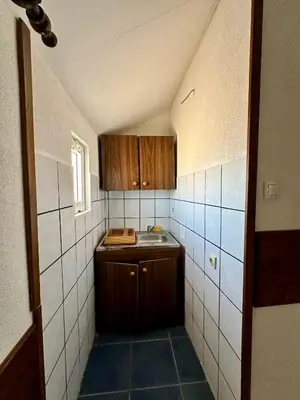 a small kitchen with a sink and a counter at Heaven Apartments in Ulcinj