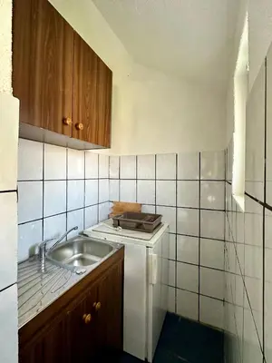a small kitchen with a sink and a counter at Heaven Apartments in Ulcinj