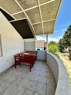 a patio with a table and benches on a balcony at Heaven Apartments in Ulcinj