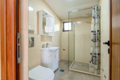 a bathroom with a toilet and a shower and a sink at Apartmani Sonja i Branko in Sutomore