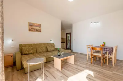 a living room with a couch and a table at Apartmani Sonja i Branko in Sutomore