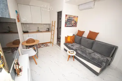 a living room with a couch and a kitchen at CENTAR Apartmant in Bar