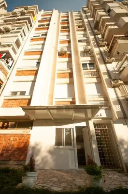 a tall white building with balconies on it at CENTAR Apartmant in Bar