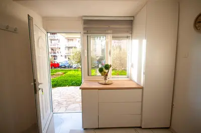 a room with a window with a vase of flowers on a counter at CENTAR Apartmant in Bar