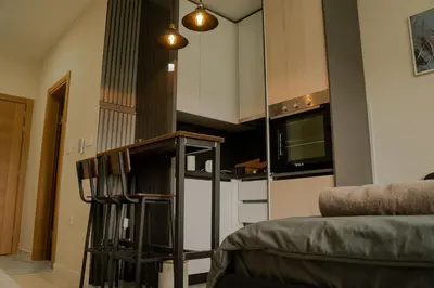 a kitchen with a stove top oven next to a microwave at Southern Retreat in Podgorica