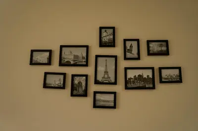 a group of framed pictures on a wall at Southern Retreat in Podgorica