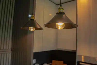 two lights hanging from a mirror in a room at Southern Retreat in Podgorica