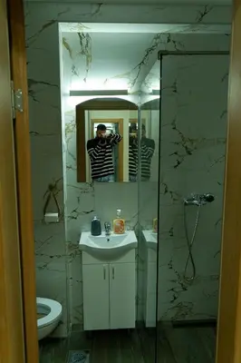 a man taking a picture of a bathroom mirror at Southern Retreat in Podgorica