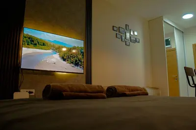 a bedroom with a flat screen tv on the wall at Southern Retreat in Podgorica