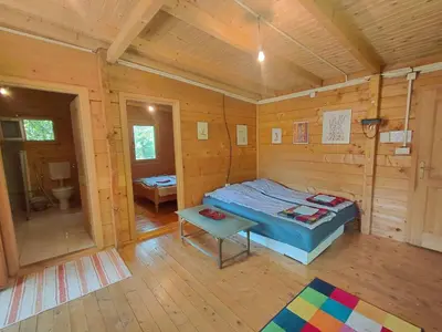 a bedroom with a bed in a wooden cabin at comjun in Ada