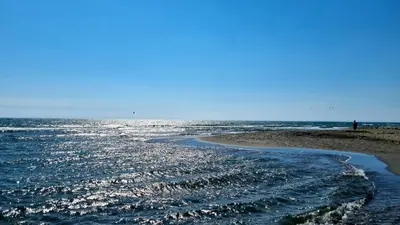 a view of the ocean from a beach at comjun in Ada