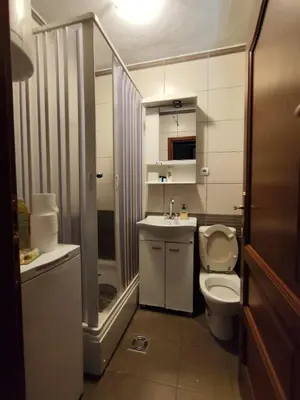 a bathroom with a toilet and a sink and a shower at Rooms Milena in Rijeka Crnojevića