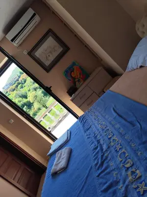 a bedroom with a bed and a large window at Rooms Milena in Rijeka Crnojevića