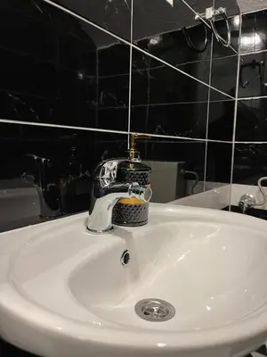 a bathroom sink with a soap dispenser on it at Apartman MIO in Pržice