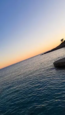 a large body of water with a sunset in the background at Meli Apartman in Krimovice