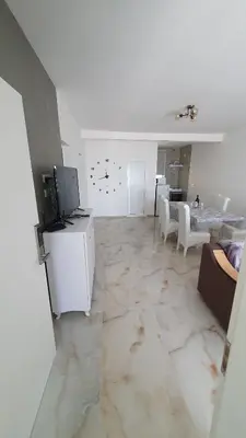 a living room with a couch and a tv and tables at Meli Apartman in Krimovice