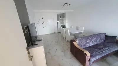 a living room with a couch and a dining table at Meli Apartman in Krimovice