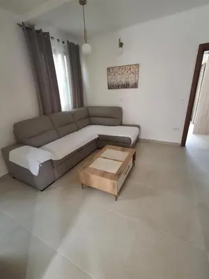a living room with a couch and a coffee table at Tims apartment in Mrčevac