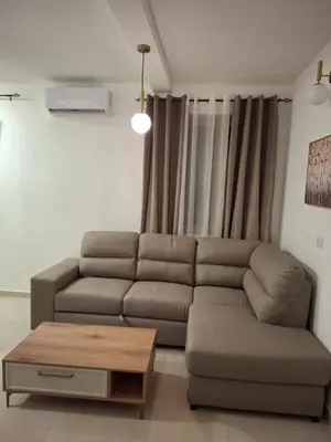 a living room with a couch and a coffee table at Tims apartment in Mrčevac