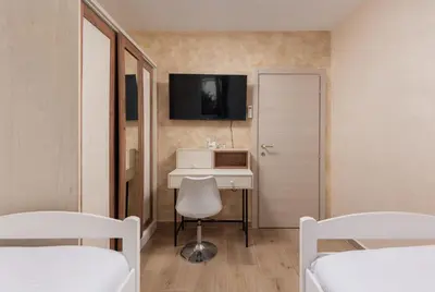 a room with two beds and a desk and a tv at Petrovic Family - Two Bedroom Apartment in Kotor