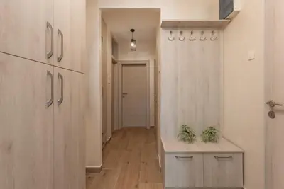 a hallway with wood floors and a hallway with a door at Petrovic Family - Two Bedroom Apartment in Kotor
