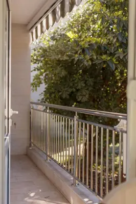 a balcony with a fence and a bush at Petrovic Family - Two Bedroom Apartment in Kotor