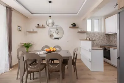 a kitchen and dining room with a table and chairs at Petrovic Family - Two Bedroom Apartment in Kotor