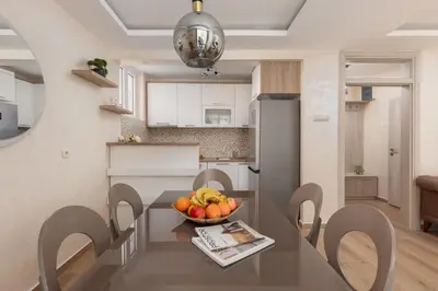 a kitchen with a table with a bowl of fruit on it at Petrovic Family - Two Bedroom Apartment in Kotor