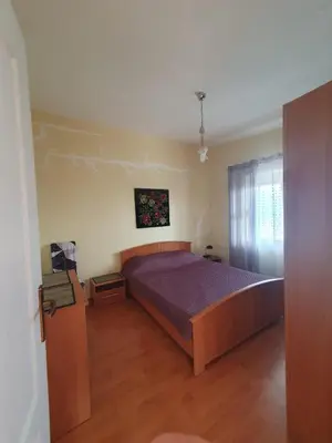 a bedroom with a large bed with a purple blanket at Traumhafte Wohnung mit Meerblick in Sutomore in Sutomore
