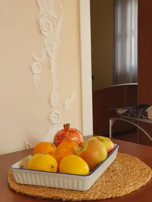 a bowl of fruit with an apple and oranges on a table at Traumhafte Wohnung mit Meerblick in Sutomore in Sutomore