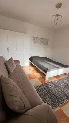 a living room with a couch and a bed at GreenHouse in Bar