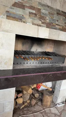 an overhead view of a stone fireplace with food on it at GreenHouse in Bar