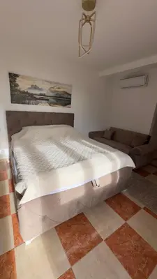 a large bed in a room with a couch at GreenHouse in Bar
