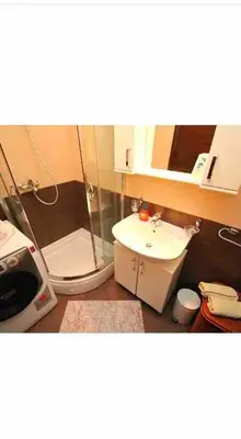 a bathroom with a shower and a toilet and a sink at Izvor in Budva