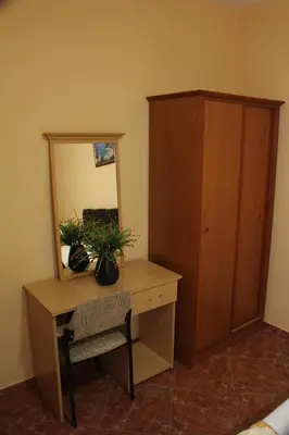 a desk with a mirror and a chair in a room at Casa Hena in Ulcinj