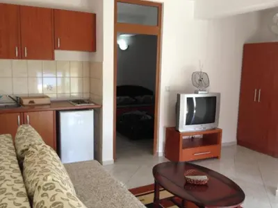 a living room with a couch and a tv at Casa Hena in Ulcinj