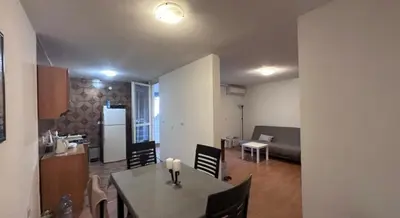 a kitchen and dining room with a table and chairs at Stan na dan in Bar