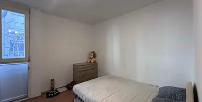 a bedroom with a bed and a dresser and a window at Stan na dan in Bar