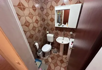 a small bathroom with a toilet and a sink at Stan na dan in Bar