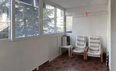 two chairs sitting in a room with windows at Stan na dan in Bar