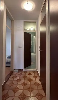 a hallway with a door leading to a bedroom at Stan na dan in Bar