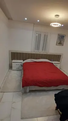 a bedroom with a bed with a red blanket at Linda Apartments in Ulcinj