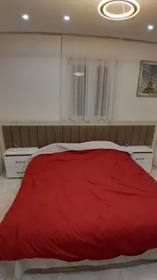 a bedroom with a large red bed in it at Linda Apartments in Ulcinj