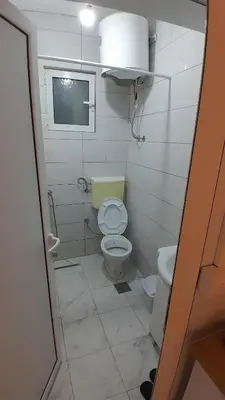 a small bathroom with a toilet and a sink at Linda Apartments in Ulcinj