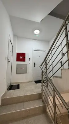 a staircase in a building with a door and a stair case at Podgorica apartment - up to 4 persons in Podgorica