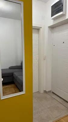 a living room with a mirror and a couch at Podgorica apartment - up to 4 persons in Podgorica