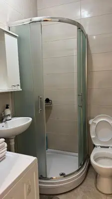 a bathroom with a shower with a toilet and a sink at Podgorica apartment - up to 4 persons in Podgorica
