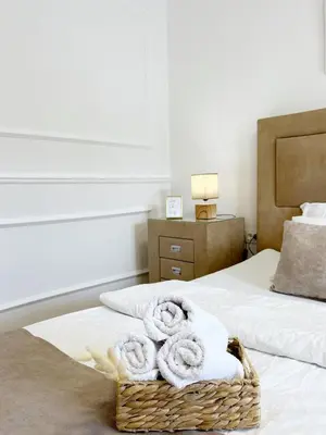 a bedroom with two towels in a basket on a bed at Luxury Lana apartments in Bar