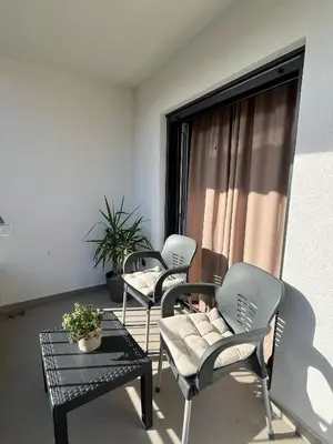 two chairs and a table in a living room at Luxury Lana apartments in Bar