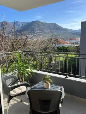 a balcony with a table and chairs and mountains at Luxury Lana apartments in Bar